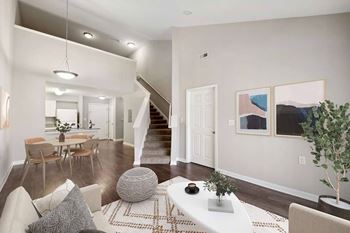 A living room with a white couch and a rug
